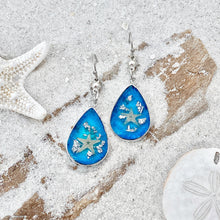 Load image into Gallery viewer, Under the Sea Earrings are displayed by being placed on top of a sand covered driftwood.