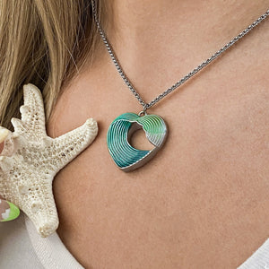 Wave Heart Necklace being worn around a woman's neck.