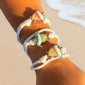 All White Rope Sand Sea Turtle Bracelets are worn on a woman's arm.