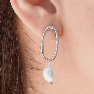 .925 Silver Pearl Irregular Oval Earring displayed closely by being worn on a woman's ear.