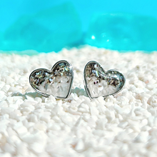 Load image into Gallery viewer, Abalone Sand Heart Studs elegantly showcased on a bed of white pebbles.