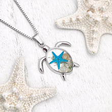 Load image into Gallery viewer, Deep in the Ocean Sea Turtle Necklace displayed on a white wooden surface.