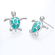 Load image into Gallery viewer, Enamel Sea Turtle Studs displayed on a white smooth surface against a white background.