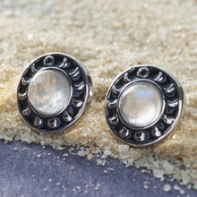 Load image into Gallery viewer, Moonstone Moon Phase Studs placed on sandy grains.