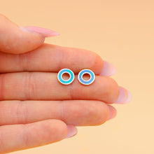 Load image into Gallery viewer, Opal Floatie Studs are displayed by placing them on a woman&#39;s palm, nestled between her two fingers.