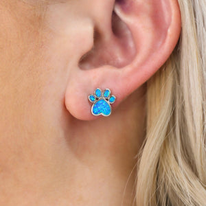 Opal Love Paw Stud displayed closely by being worn on a woman's ear.