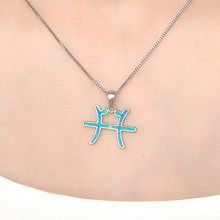 Load image into Gallery viewer, Opal Pisces Necklace displayed closely by being worn around a woman&#39;s neck.