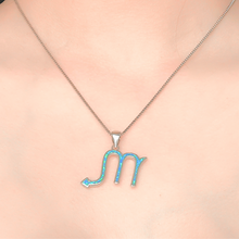 Load image into Gallery viewer, Opal Scorpio Necklace displayed closely by being worn around a woman&#39;s neck.