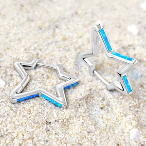 Opal Star Hoop Earrings are displayed on a sandy surface.