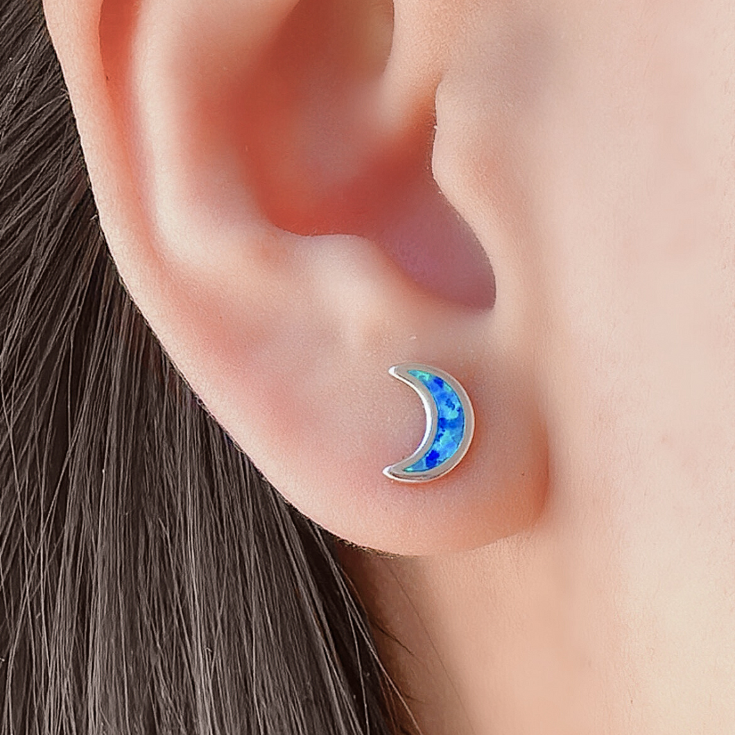 Opal Star Moon Mismatched Stud displayed closely by being worn on a woman's ear.