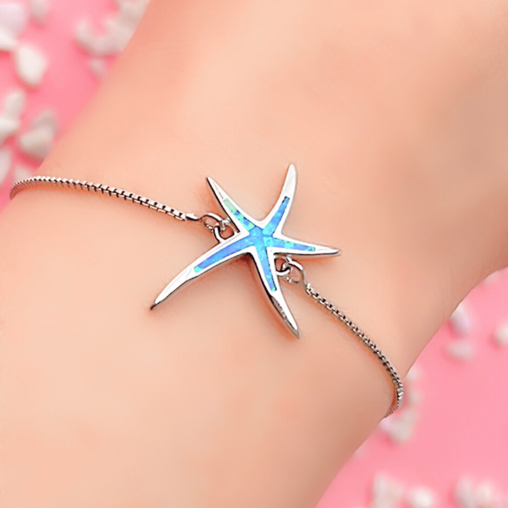 Opal Starfish Bracelet displayed closely by being worn around a woman's wrist.