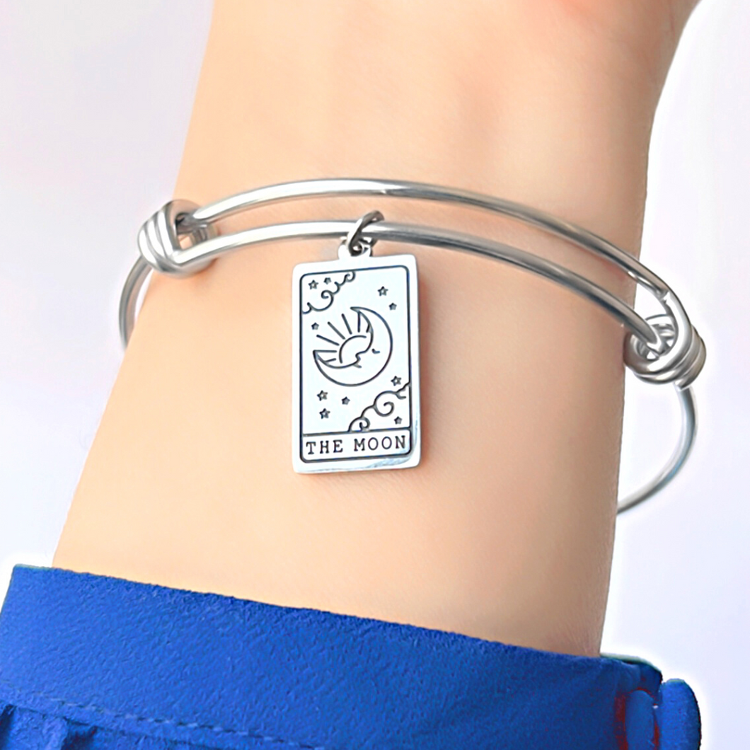 The Moon Tarot Card Bracelet displayed by being worn around a woman's wrist.