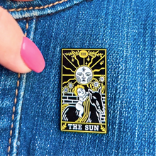 Load image into Gallery viewer, The Sun Tarot Card Pin displayed on denim cloth.