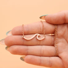Load image into Gallery viewer, Wave Necklace displayed by being held on a woman&#39;s palm.