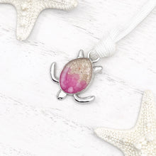 Load image into Gallery viewer, White Rope Sand Sea Turtle Bracelet in Pink Pebble is displayed on a white wooden surface.