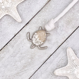 White Rope Sand Sea Turtle Bracelet in White Turquoise is displayed on a white wooden surface.
