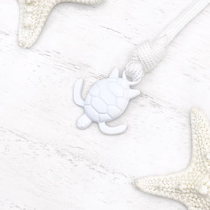 Whiteout Sea Turtle Bracelet displayed on a white wooden surface.